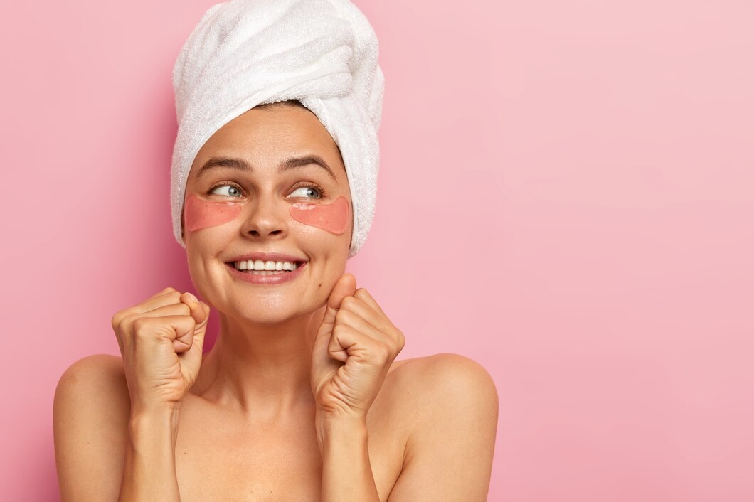 woman-clenches-teeth-fists-looks-away-with-glad-expression-wears-white-soft-towel-head-has-naked-shoulders_273609-33232